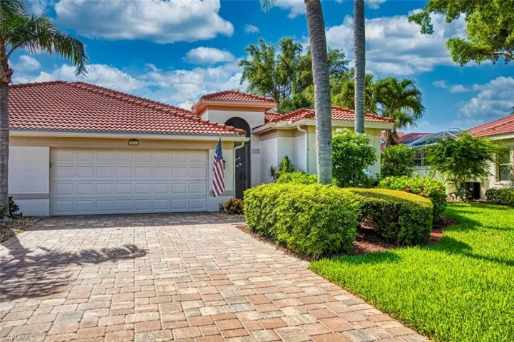 Mediterranean / spanish home with a garage and a front yard