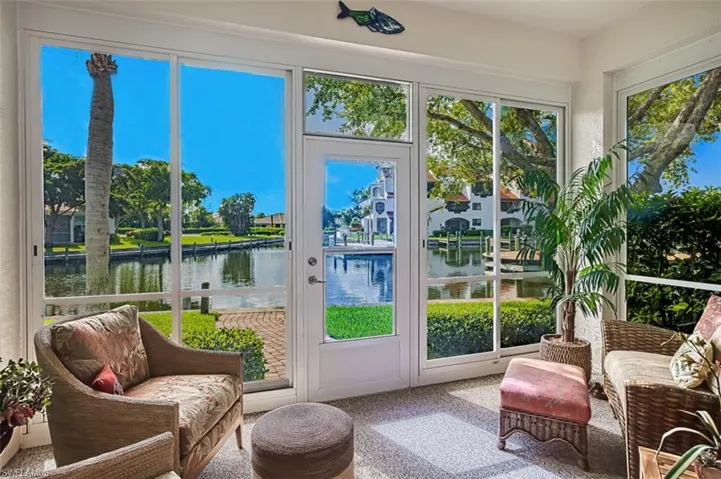 Sunroom featuring a water view