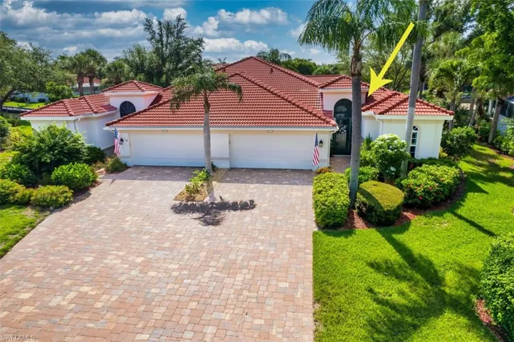 Mediterranean / spanish home with a garage and a front lawn