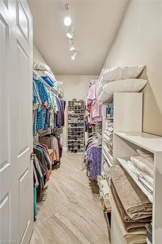 Spacious closet with light tile patterned floors