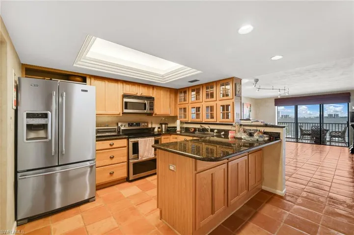 Large thick slab stone countertops & lots of cabinets