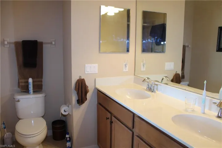 Master Bathroom featuring double vanity and light tile patterned flooring