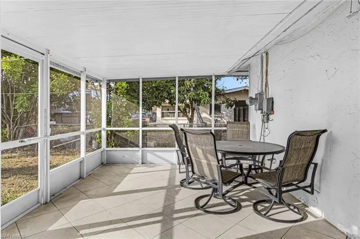 Sunroom / solarium featuring outdoor dining space