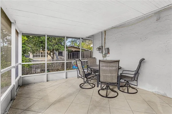 Sunroom featuring outdoor dining area