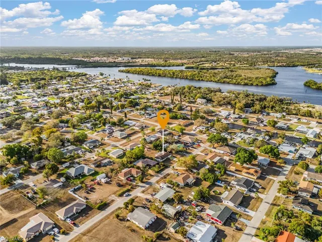 Aerial perspective of suburban area with a nearby body of water