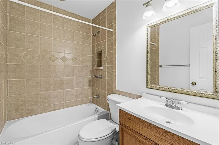 Full bath featuring vanity and shower / washtub combination