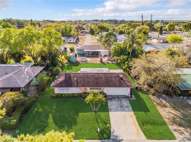 Aerial perspective of suburban area featuring a tree filled landscape