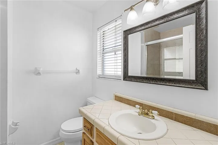 Full bathroom featuring vanity and a shower with shower door