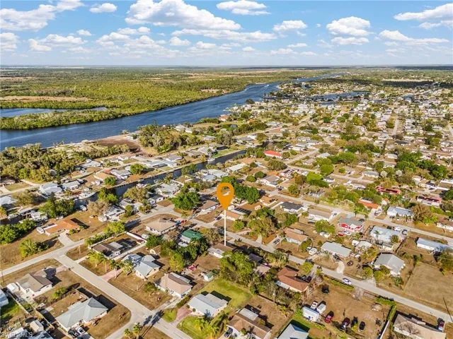 Aerial view of residential area featuring a nearby body of water