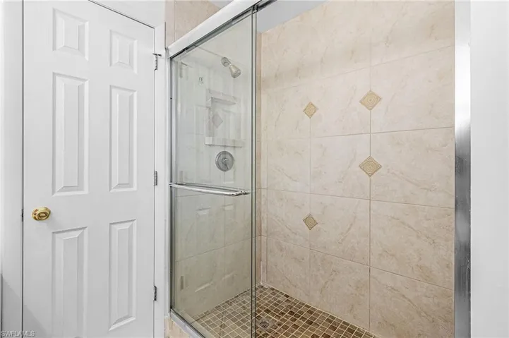 Full bathroom featuring a shower stall