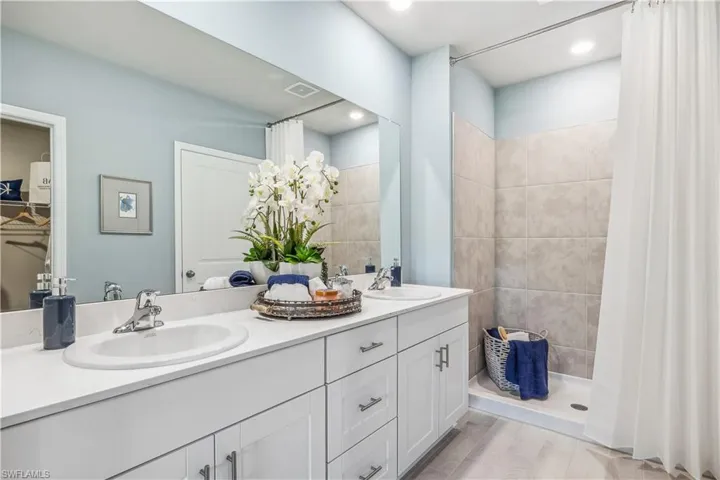 Bathroom with double sink vanity and walk in shower