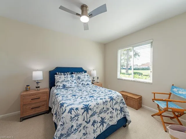 Bedroom featuring light carpet and ceiling fan