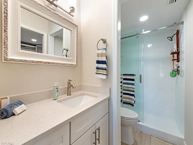 Bathroom featuring vanity, a stall shower, and recessed lighting