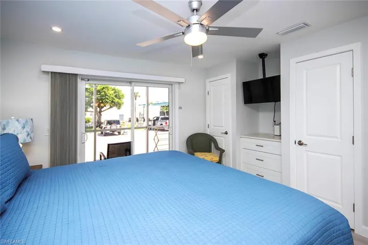 Bedroom with access to screened lanai and ceiling fan
