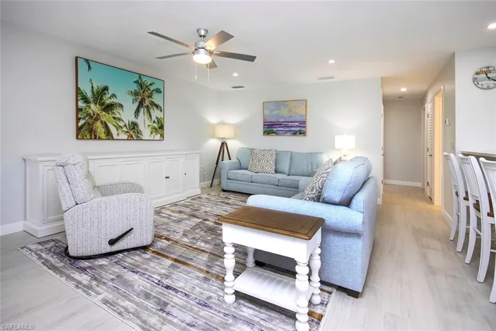 Living room with light, a ceiling fan, and recessed lighting