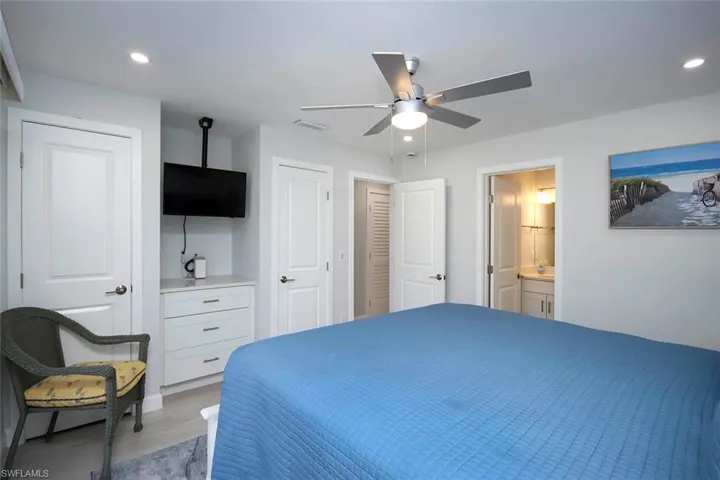 Bedroom featuring recessed lighting, a ceiling fan, two closets, and ensuite bath