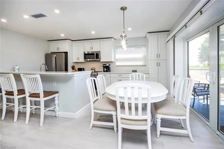 Dining area featuring recessed lighting.