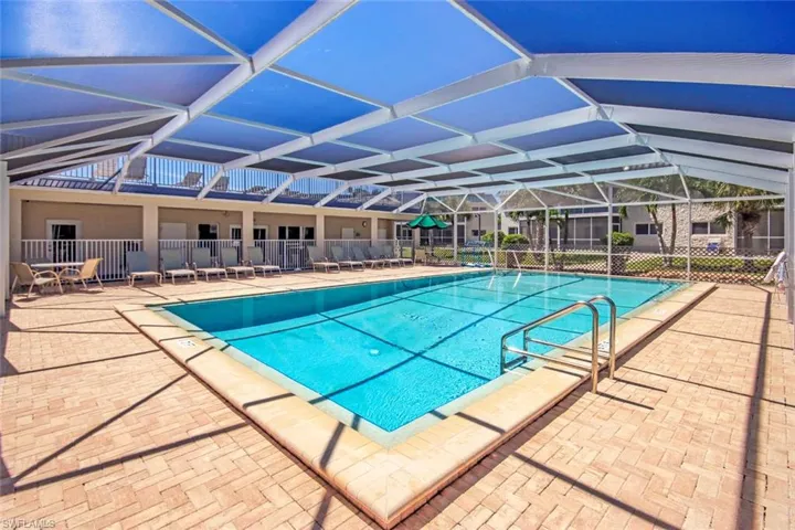 Community pool with a patio area and a lanai