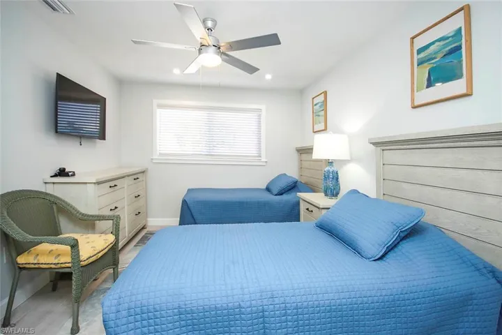 Bedroom with ceiling fan, wood finished floors, and recessed lighting