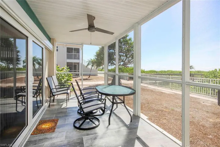 Screened lanai with a ceiling fan and plenty of natural light