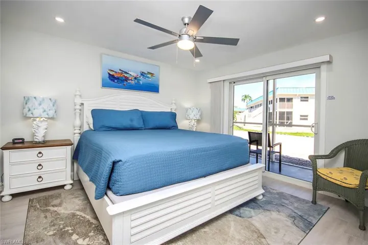 Bedroom featuring light wood-style Plank tile floors, access to exterior, recessed lighting, and a ceiling fan