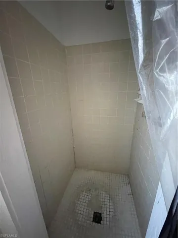 Unit 2: Bathroom featuring tiled shower