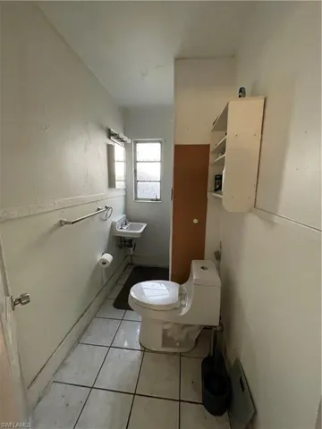 Unit 2: Bathroom featuring sink, tile patterned flooring, and toilet