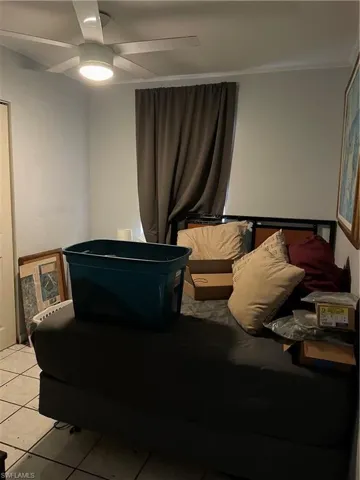 Unit 2: Tiled bedroom featuring ceiling fan