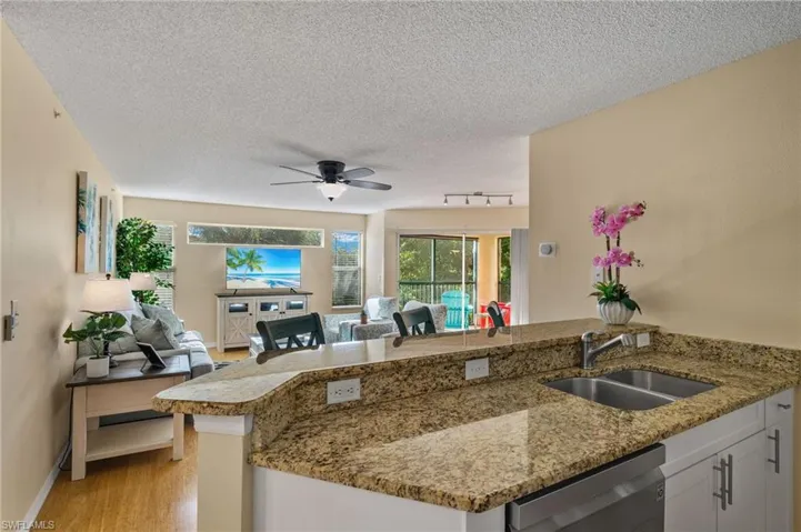 Kitchen with light hardwood / wood-style flooring, sink, a textured ceiling, dishwasher, and ceiling fan