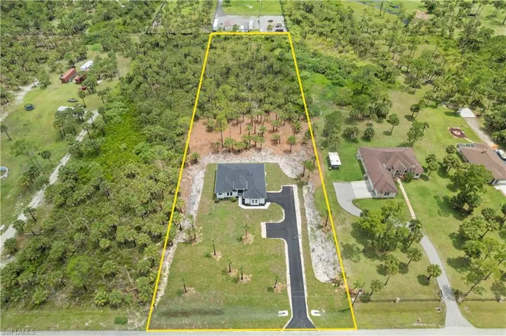 Aerial view of property and surrounding area with property parcel outlined
