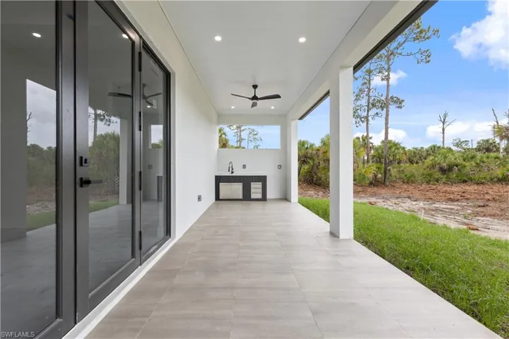 View of patio featuring a ceiling fan and a sink