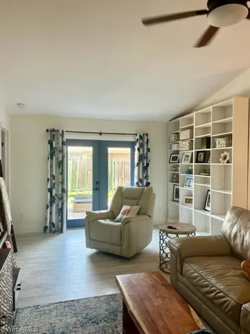 Living room featuring french doors, light hardwood / wood-style flooring, and ceiling fan