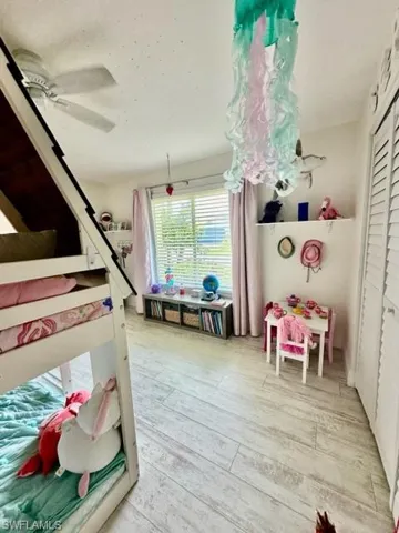 Bedroom featuring light hardwood / wood-style flooring, a closet, and ceiling fan