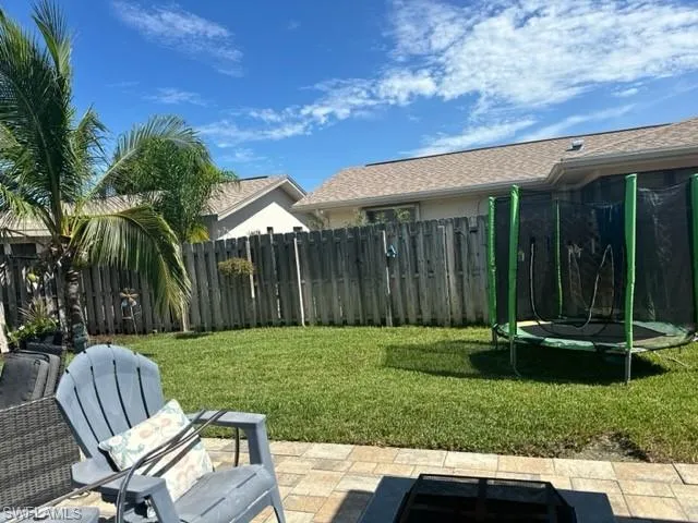 View of yard with a patio and a trampoline