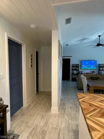 Hallway with light hardwood / wood-style flooring