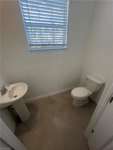 Bathroom featuring baseboards and tile patterned flooring