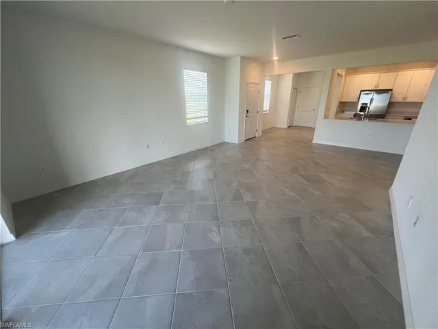 Unfurnished living room featuring light tile patterned flooring