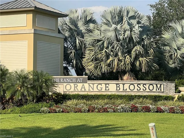 Community / neighborhood sign featuring a yard