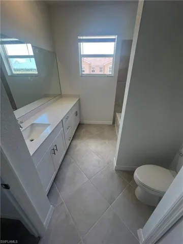 Bathroom with vanity and light tile patterned flooring