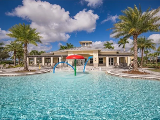 Community pool with a patio and a water play area