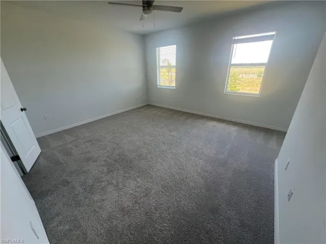 Empty room with carpet and healthy amount of natural light