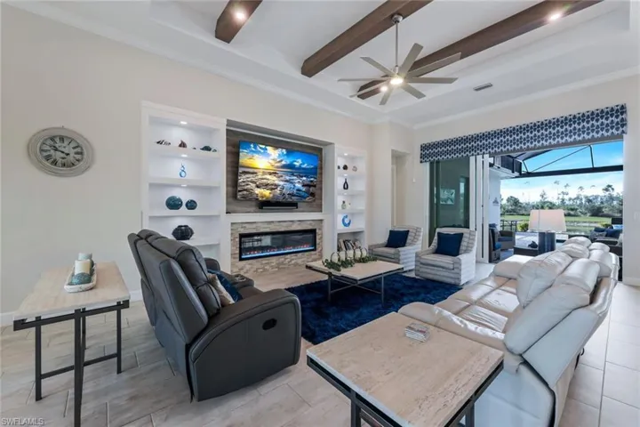 The Custom work in this home is STUNNING -- Custom Built-in lighted Shelving, fireplace, architectural ceiling beams with integrated lighting. Simply GORGEOUS!