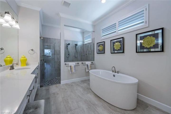 This spa-like owner bath is simply gorgeous--note the oversize soaking stand-alone tub, huge walk-in shower with dual shower heads, dual sinks, and plenty of vanity space.