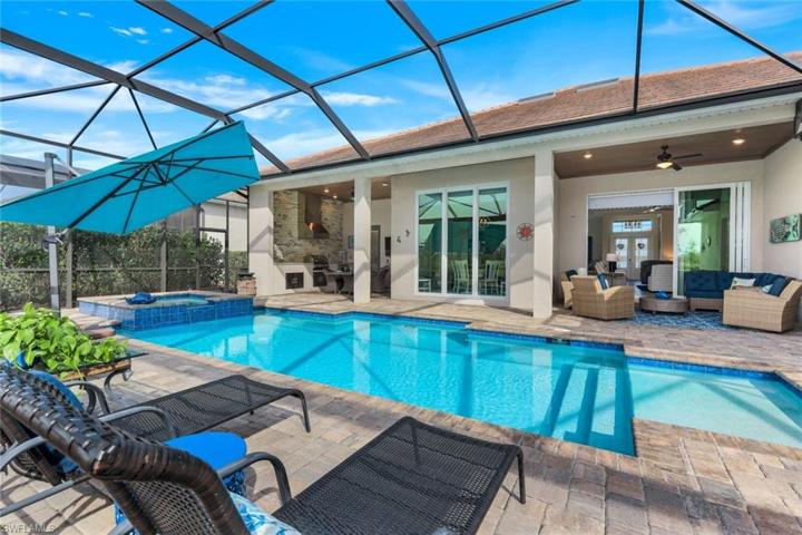 This outdoor space is really something special... extended pavers on the opposite side of the pool give this home a real "resort-style" feel!