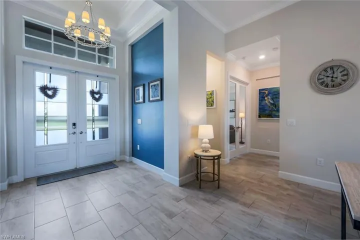 Greet your guests in this open and welcoming foyer entry with decorative impact glass and designer lighting.