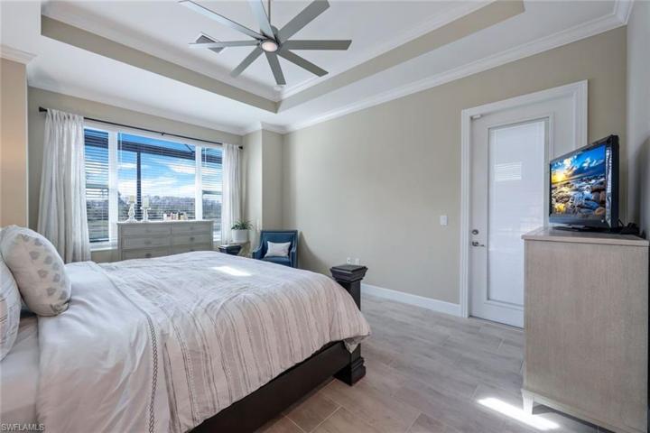 This primary bedroom is just steps from the pool and outdoor living area.