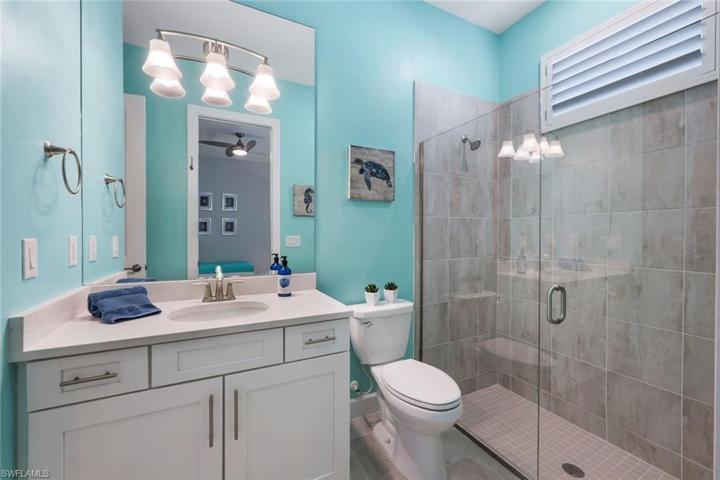 This ensuite/guest bath includes plantation shutter, frameless glass, and walk-in shower.