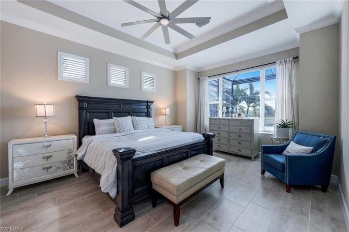 The owner suite is your private oasis and features plantation shutters, crown molding, HUGE his/hers closets, and a separate door leading to the outdoor lanai and gathering space.