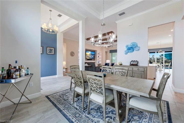 The formal dining room features tray ceilings, crown molding, and lots of natural light.