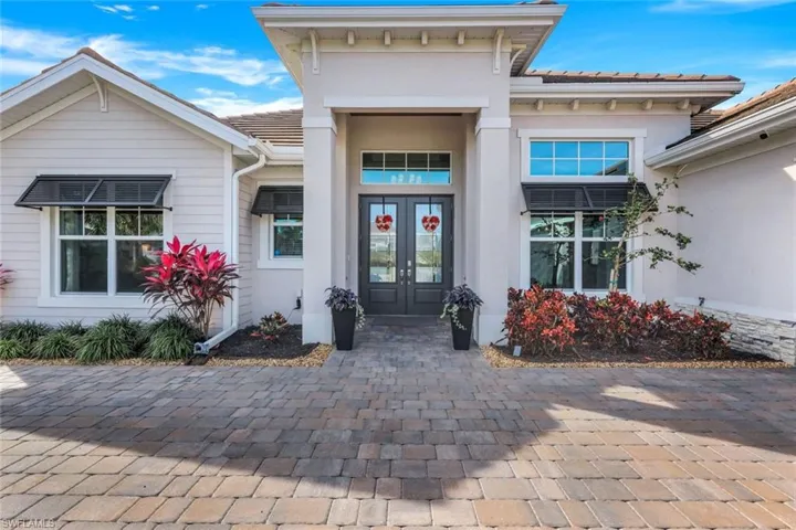 Fabulous curb appeal--professionally landscaped with outdoor lighting and NEW Bermuda Shutters.